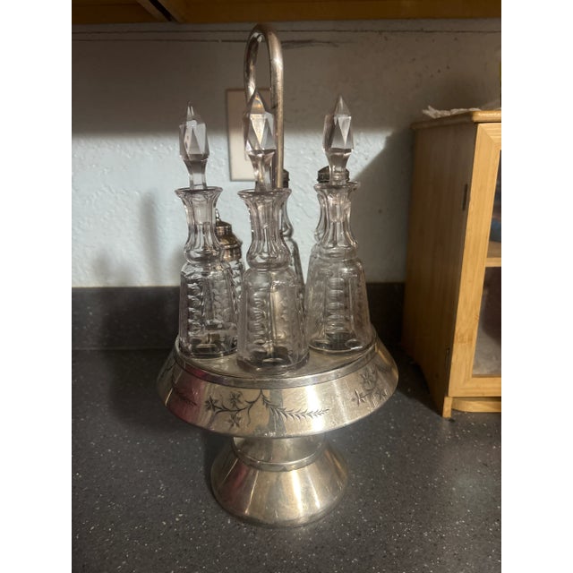 Elegant antique Victorian cruet set by Palmer Manufacturing Co., featuring beautifully etched glass bottles in a detailed...