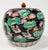 Vintage Chinese lidded melon jar with lotus leaf and water bird nature motif. Features black base with vibrant scenes...