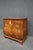 Weiman cherry Bombay commode featuring a shaped front, four drawers, brass hardware, and beautiful cherry veneer detail.