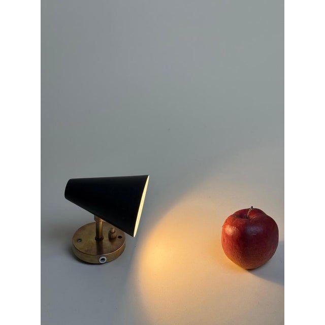 This stylish set of two wall lamps embodies the timeless charm of 1960s Scandinavian modernism. The lamps impress with...