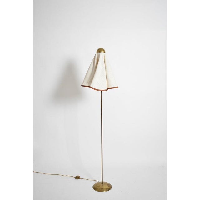 Brass, fabric and leather floor lamp, 1960s. Height: 165 cm - 64.96 in Length: 50 cm - 19.69 in Width: 40 cm - 15.75 in...