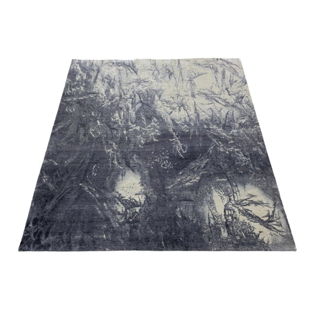 This contemporary hand-knotted rug boasts a striking abstract design that instantly draws the eye. Crafted from premium...