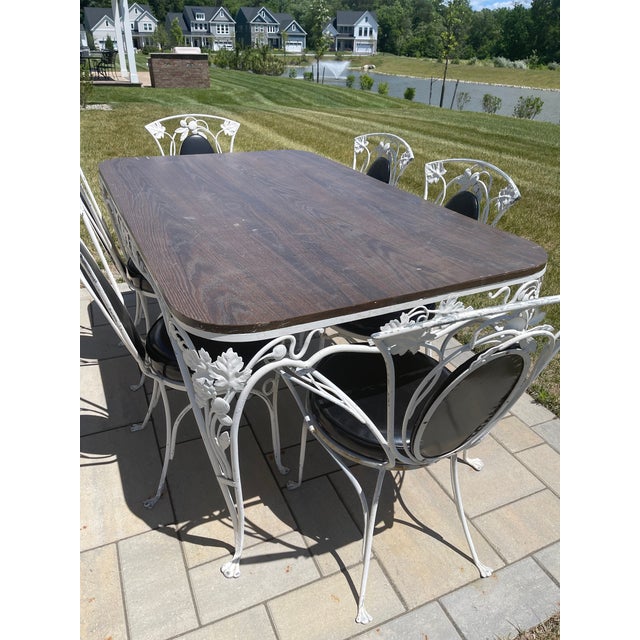 Beautiful Salterini 1940s patio set including a table, a wood table top, 4 side chairs and 2 armchairs. The chairs have...