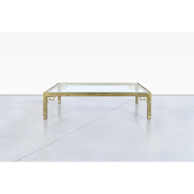 This exquisite coffee table is an outstanding example of vintage Hollywood Regency design. Crafted in the United States...