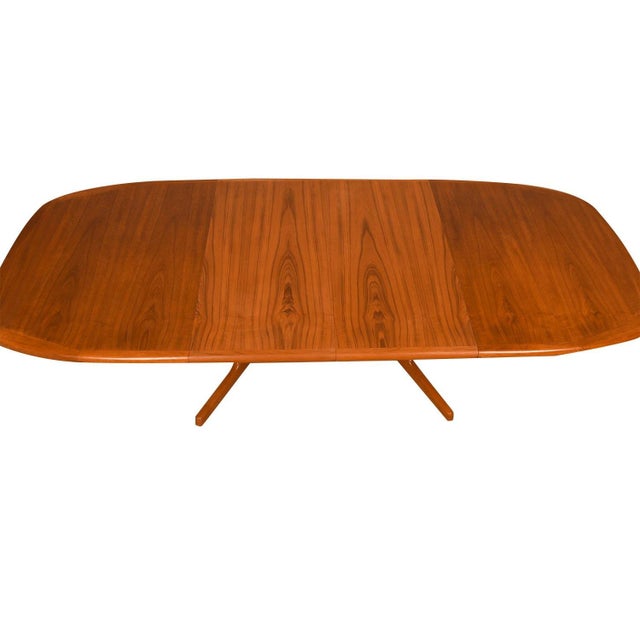 Beautiful Mid-Century Modern expandable dining table, circa 1970’s by Dyrlund. Featuring richly grained, gleaming teak and...