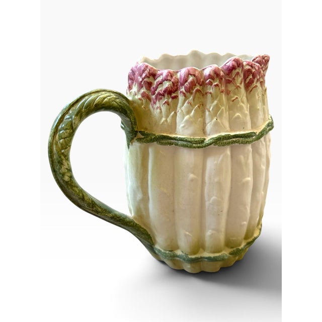 A delightful example of Italian trompe-l’œil pottery, this vintage Majolica-style pitcher is sculpted and painted to...