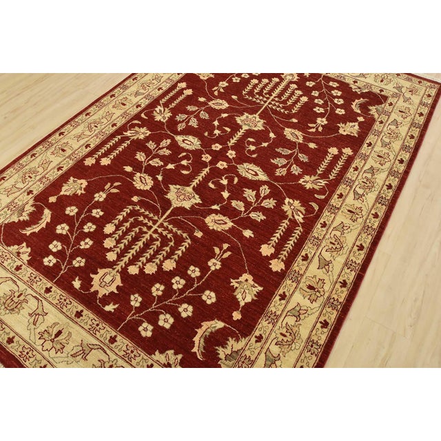 A traditional Ziegler rug hand-knotted with fine wool on a cotton foundation. This rug features a botanical design set...