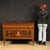 An elegant mid-20th-century Italian dresser. This Louis XVI-style furniture is richly inlaid with walnut, rosewood, maple,...