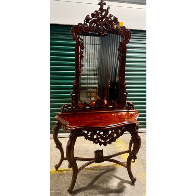 This is a vintage console table paired with a matching ornate wall mirror. It features intricate hand-carved grape motifs...