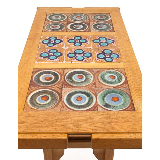 Oak rise-and-drop dining table by Guillerme and Chambron. 18 ceramic tiles by Boleslaw Danikowski. Convertible into a...