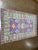 Hand-knotted Pakistani Kazak wool rug featuring a vibrant field with geometric medallions and stylized tribal motifs...