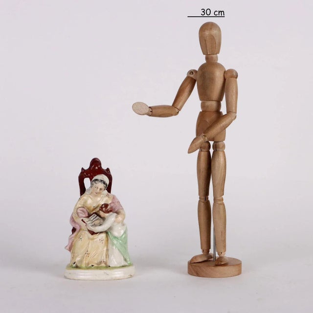 Staffordshire porcelain figurine depicting the figure of a woman with child. This piece is attributed to the mentioned...