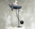 This large vintage kinetic sculpture depicts a sailor standing in a stylized boat, designed as a classic “sky hook” or...