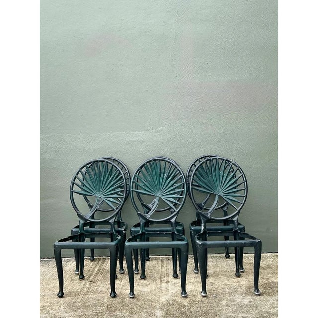This set of six vintage outdoor dining chairs is cast in iron, each featuring an oval backrest filled with a striking,...