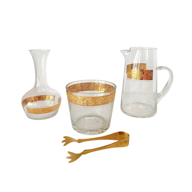A set of midcentury modern glassware from the Tyrol collection by Culver. Decorated with a bold 22 karat gold band...