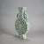 An antique Japanese pillow vase offers pottery construction with green glaze, scroll and foliate moriage elements in...