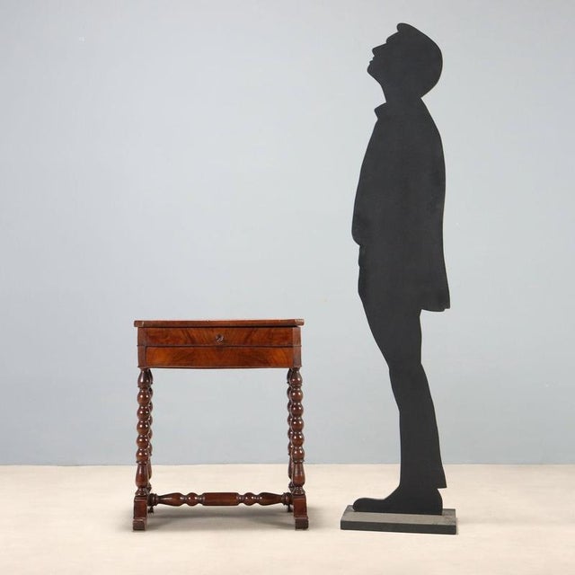 Luigi Filippo work table, crafted in Italy in the mid-19th century, veneered in walnut burr. The hinged, lift-top conceals...