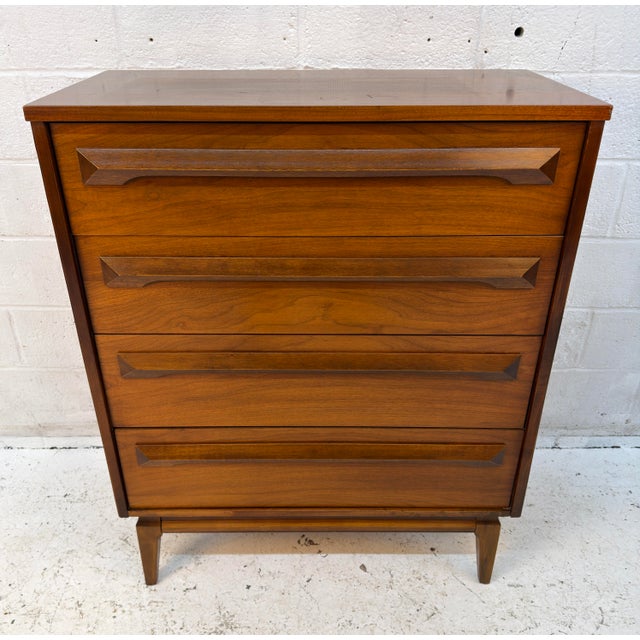 This walnut highboy dresser is crafted in the clean lines and simple elegance of iconic mid-century modern design. These...