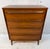This walnut highboy dresser is crafted in the clean lines and simple elegance of iconic mid-century modern design. These...