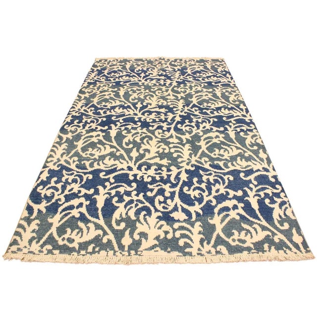 This elegant hand knotted rug features a modern fusion of beauty, with its interlocking geometric and minimalist pattern....