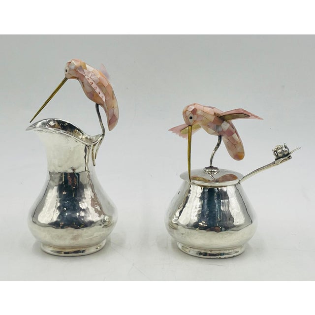 Whimsical Los Castillo silver hummingbird creamer, lidded sugar bowl, and matching ladle, handcrafted in Taxco, Mexico,...