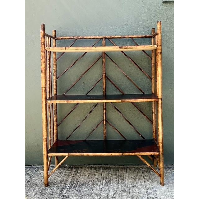 Elevate your interior with the exotic allure of this vintage Chinoiserie bamboo etagere. A masterclass in eclectic design,...
