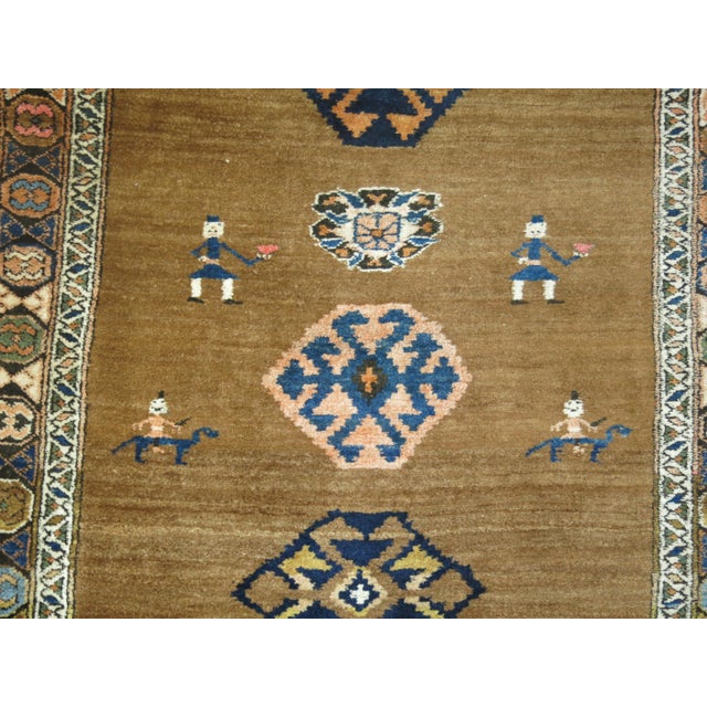 Make a bold statement in a hallway with this early 20th century tribal Persian Serab runner featuring a folksy motif on a...