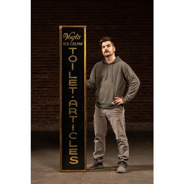 This tall reverse-painted glass sign with gold leaf, dating from around the turn of the century, advertises Vogt's Ice...