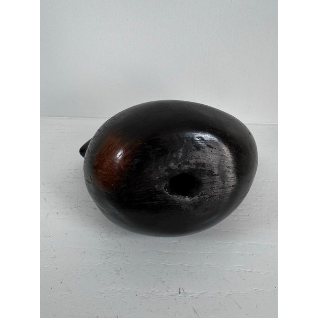 A sculptural pair of vintage Mexican black clay bird figures, hand-formed and kiln-fired with a hollow interior and...