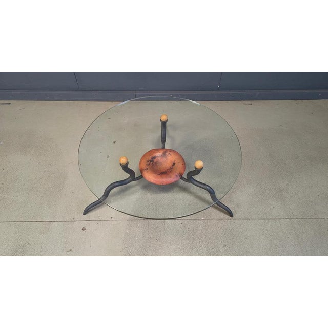 Exclusive vintage coffee table with elegant wrought iron legs and a clear glass top. Copper center plate Made by a dutch...