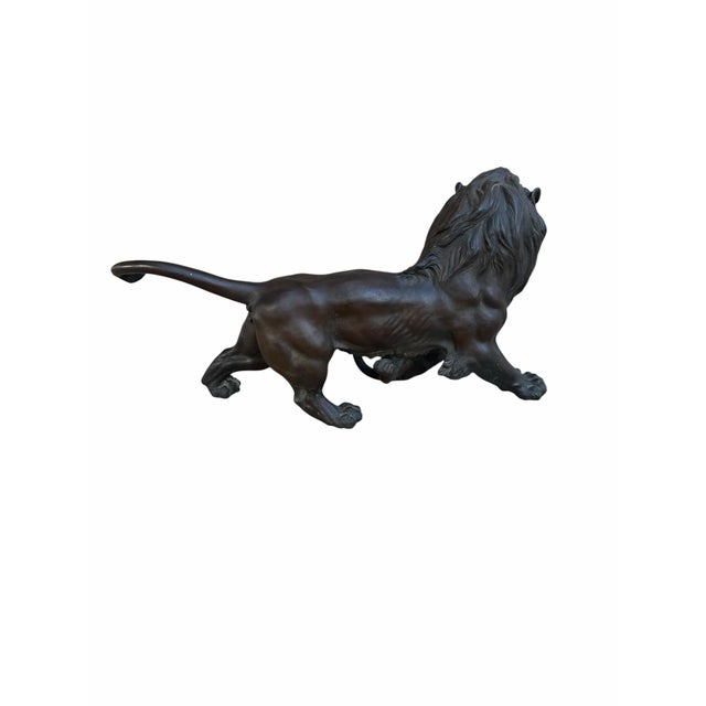 Antique Patinated Bronze Lion and Tiger Animalier Sculpture An antique patinated bronze sculpture depicting a fierce...