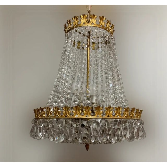 Italian rock crystal empire style chandelier. 60's. Original finish in gold leaf on bronze. Six bulbs Up to 250V...