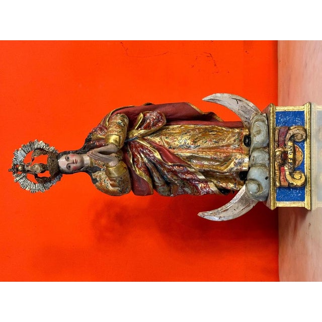 An exceptional Baroque wood carving, polychrome and gilded, depicting the Virgin of the Immaculate Conception standing on...