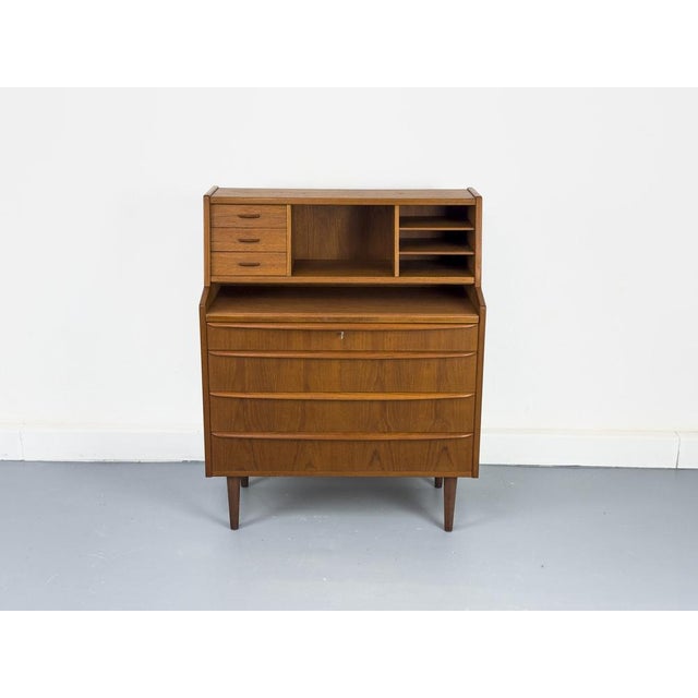 High-quality teak secretary desk from Denmark with a pull-out writing surface (81cm x 38cm). Above this are three small...