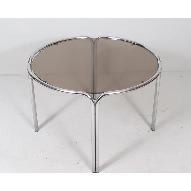 Mid-century dining table, Italy, 1970s, chrome-plated metal frame with a round smoked glass top, Dimensions approx.: H....