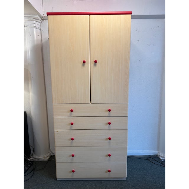 Design Plus Gallery presents a Dressing Armoire with Maple Veneer and Red Accents. The tall armoire is a two piece that is...
