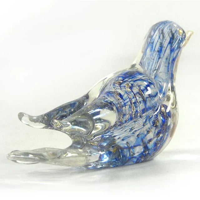 A small, pretty bird made of multi-colored crystal glass. Decorative gold particles are embedded inside. The figurine...