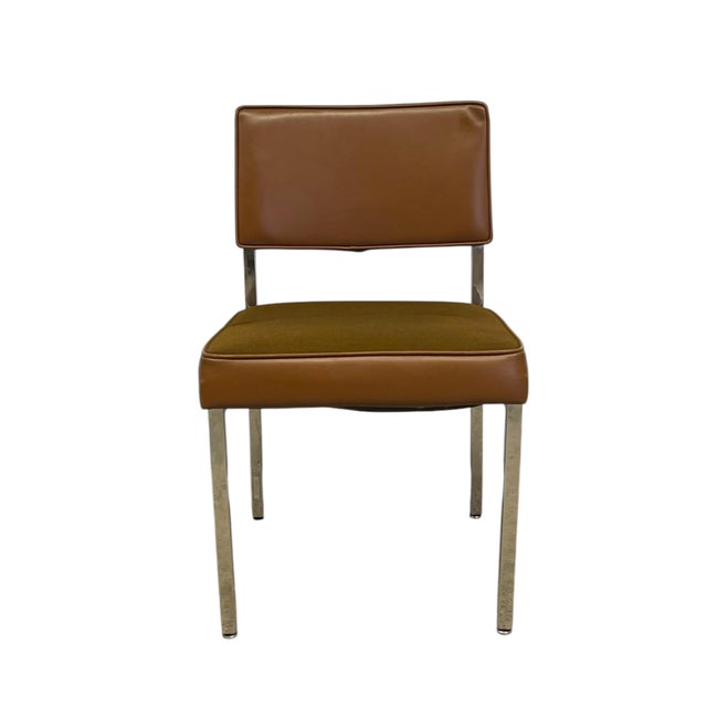 Vintage industrial dining or side chair with a steel like frame, brown seat, and brown possibly vinyl backrest.The padded...