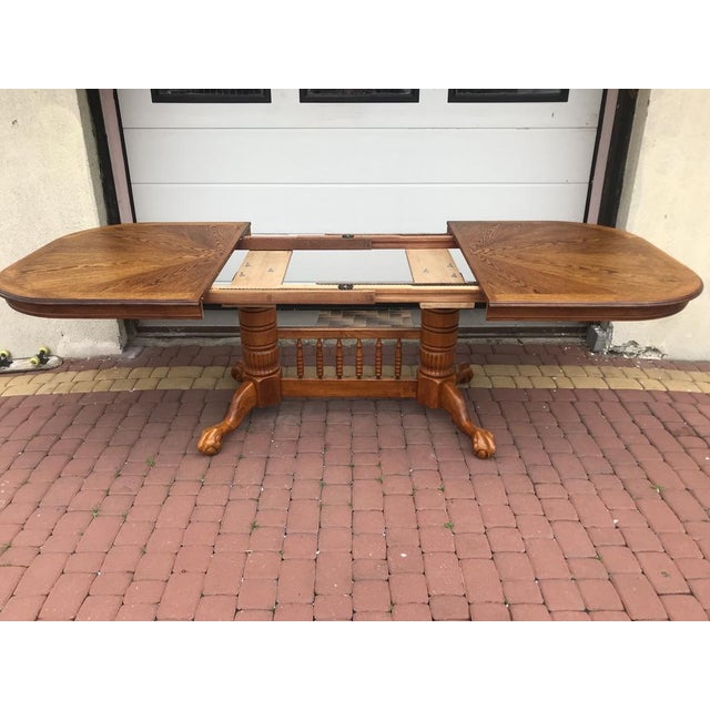 Extendable dining table with rounded corners, 1970s It stands on turned and joined legs. Made of beech wood. The table top...