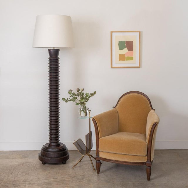 Large carved wood floor lamp by Charles Dudouyt from France, 1940s. Heavy stem with carved design on circular base with...