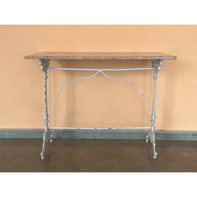 Antique cast iron French pastry style black scrolling "Butterfly" coffee table with marble top. Item features impressive...