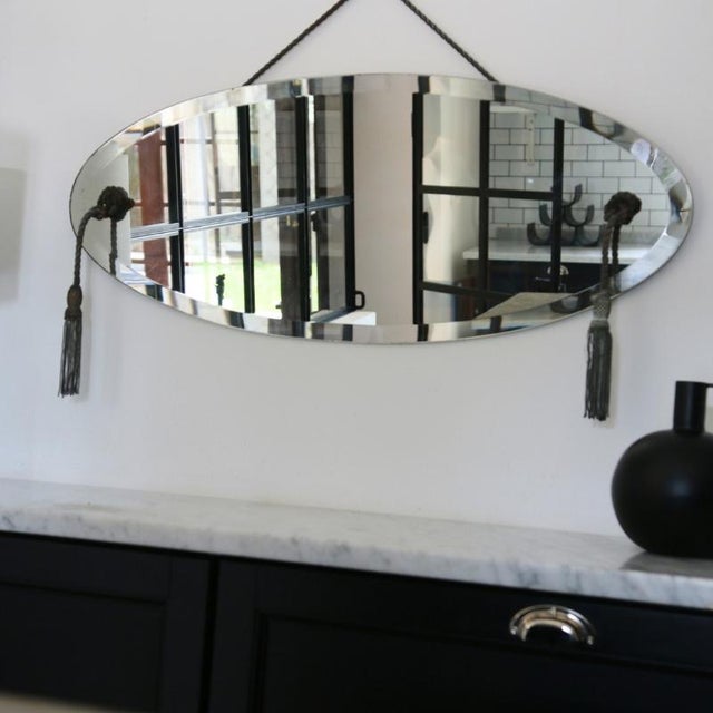 This oblong mirror, with its elongated oval shape, embodies the refinement of the 1940s and 50s and the transition between...