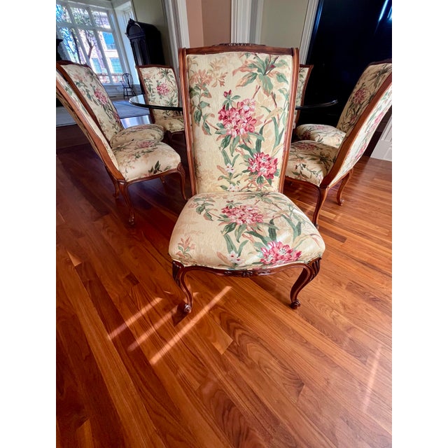 Large 72” D elegant carved wood dining table with glass top and 8 wood & upholstery floral chairs, table has rich details,...