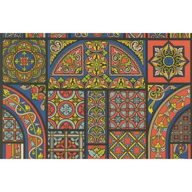 This striking chromolithograph, Plate XLIV from L'Ornement Polychrome, presents a dazzling collection of Gothic stained...