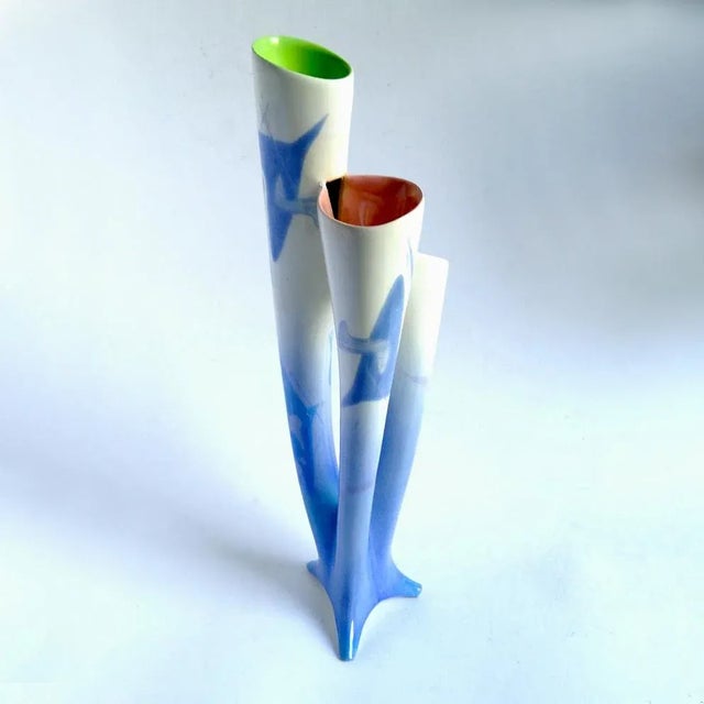 This ceramic sculptural vase features enamel decorations and a white base. It is signed Donatella and was made in Italy.