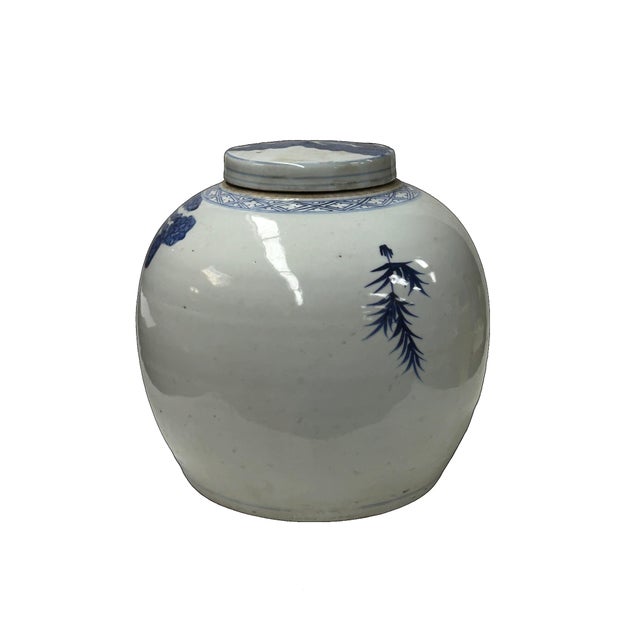 This blue and white ceramic ginger jar is a classic example of traditional Chinese pottery, featuring a stout, globular...