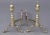 Pair American brass and iron andirons with octagonal shaped acorn tops and finials, round plinths, spurs and log stops on...
