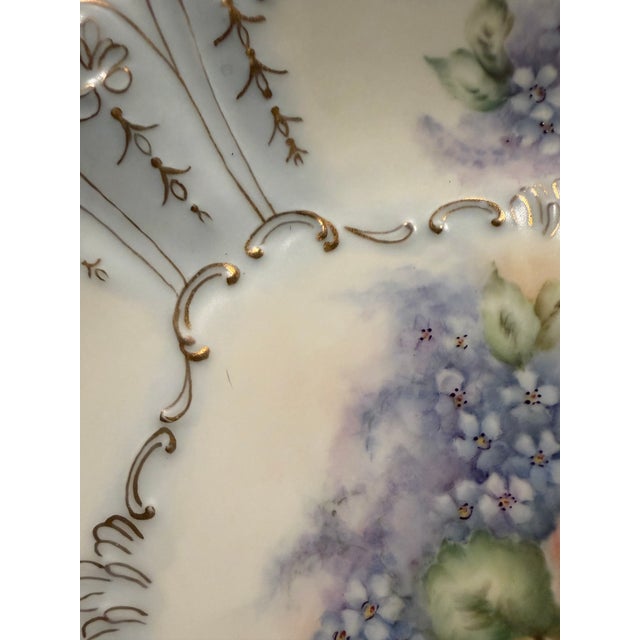 A vintage decorative plate featuring a softly scalloped, rounded-square silhouette. Signed “Cardwell,” the piece has no...