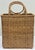 Vintage woven wicker basket featuring tall slim form and round handles to either side. Unique shape for that space that...