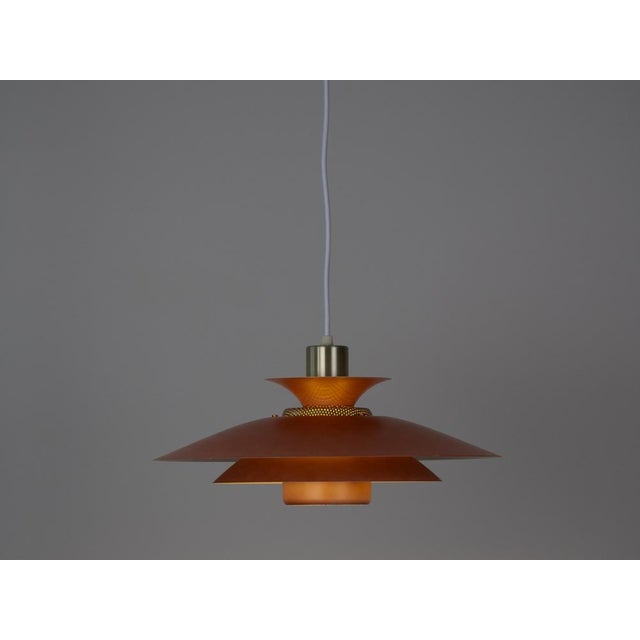 This lamp was designed by Danish designer Kurt Wiborg and manufactured by Jeka. The lamp's form is based on the principle...